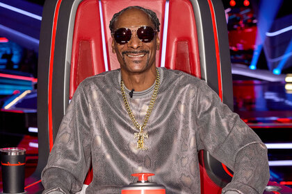 Snoop Dogg sits in his coach's chair during the Season 26 premiere of The Voice