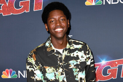 Joseph Allen smiles on the red carpet for Americas Got Talent