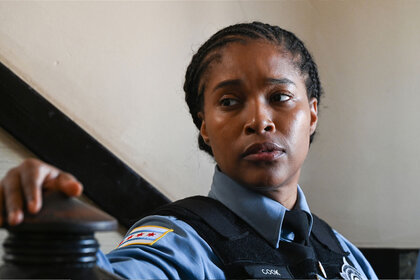 Kiana Cook (Toya Turner) stands in an apartment hallway