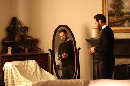 Sir looks into a mirror in a bedroom on Found Season 2 Episode 2.