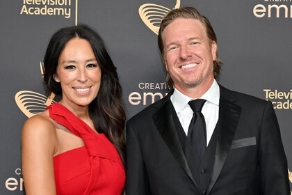 Joanna Gaines and Chip Gaines smile together on the red carpet