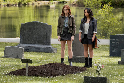 Aj and Ruby stand in a cemetery on Laid Season 1 Episode 2