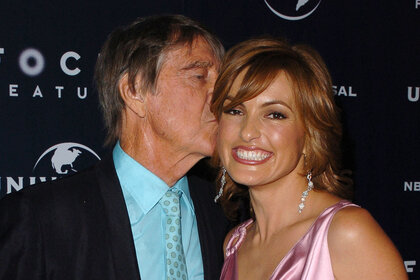 Mickey Hargitay kisses Mariska Hargitay on the head at a golden globes after party in 2005