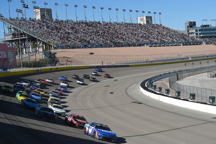 Kyle Larson leads the field through turn 1 for a restart during the NASCAR Cup Series Playoff South Point 400 in 2023.