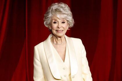 Rita Moreno wears a cream colored suit on the red carpet at the 2024 Academy Museum Gala