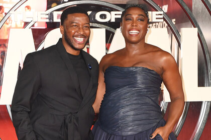 Zackary Momoh and Lashana Lynch laugh together on the red carpet at the Premiere of "The Day Of The Jackal"