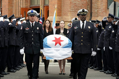 Kelly Severide and Wallace Boden hold a casket during a funeral procession on Chicago Fire Season 7 Episode 7