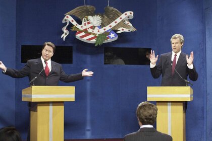 Al Gore (Darrell Hammond) and George W. Bush (Will Ferrell) debate behind podiums.