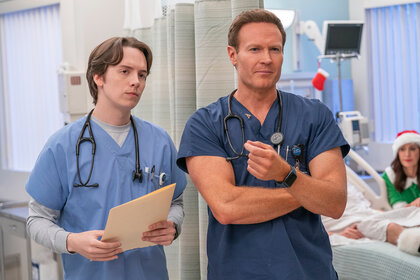 Matt and Dr. Bruce stand together in the hospital on St. Denis Medical Season 1 Episode 6.