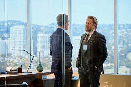 Ted Black and Stuart Lane having a conversation in a room on Suits L.A. Season 1, Episode 1.