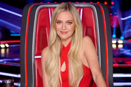 Kelsea Ballerini smiling and posing in her coach chair on The Voice Season 27, Episode 1.