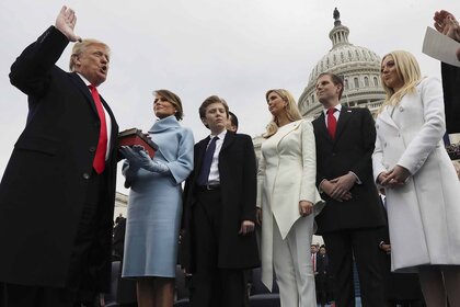 Donald Trump takes an oath in front of his family.