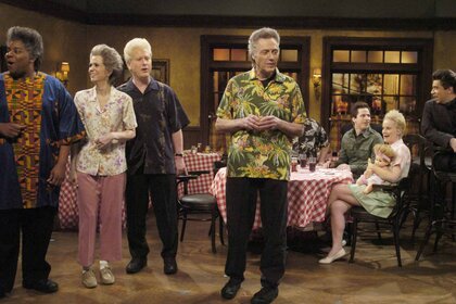 Christopher Walken and the cast of SNL sit in a restaurant on SNL Episode 3309.