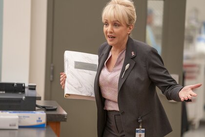 Joyce (Wendi Mclendon Covey) holds a binder on St. Denis Episode 109.