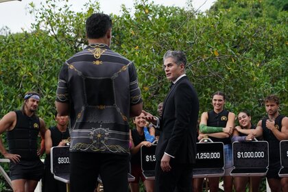 Joe Manganiello and "Dr. Will" Kirby stand in front of the cast's open briefcases on Deal or No Deal Island Episode 202