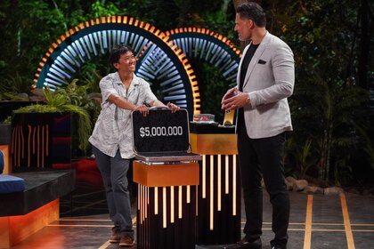 Joe Manganiello watches Dickson Wong stand with their open briefcase on Deal or No Deal Island Episode 204.