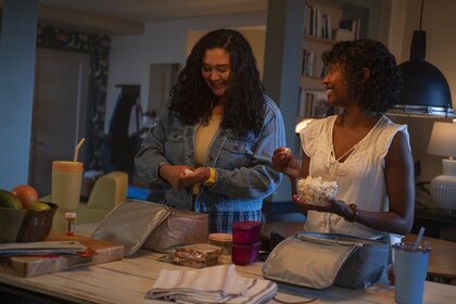 Dr. Dana Dang (Aury Krebs) and Dr. Ericka Kinney (Ashleigh LaThrop) pack lunchboxes together on Brilliant Minds Episode 113.