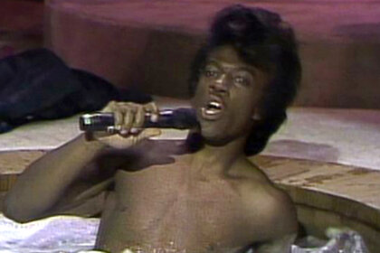 Eddie Murphy sits in a hot tub as James Brown on Saturday Night Live Season 9.