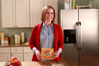 Vanessa Bayer holds up a Totinos box during a sketch on Saturday Nighy Live Season 41, Episode 12