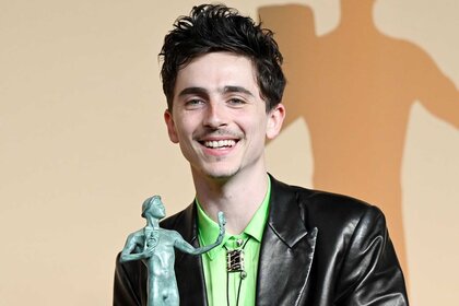 Timothée Chalamet posing with his award at the 31st Screen Actors Guild Awards.