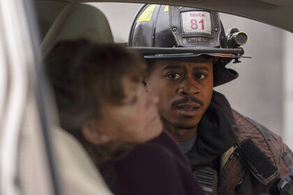 Darren Ritter looks through a car window on Chicago Fire Season 13 Episode 12