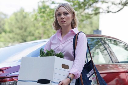 Alice carrying a box in Grosse Pointe Garden Society Season 1, Episode 1.