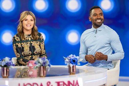 Jenna Bush Hager and Justin Sylvester smiling at a desk during the Today show.