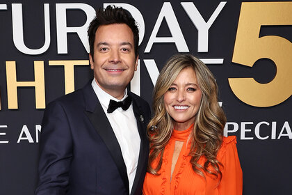 Jimmy Fallon and Nancy Juvonen smile together on the red carpt for SNL50