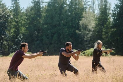 Shane Florence, Jacob Hassani, and Rebecca 'Bex' Henderson aiming guns outside in The Hunting Party Season 1, Episode 3.