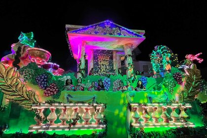 Guests on top of a float during Universal Orlando Resort's Mardi Gras Celebration.