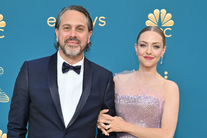 Amanda Seyfried and Thomas Sadoski smile together on the red carpet of the 2022 Emmy's