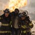 Randy "Mouch" McHolland (Christian Stolte) and Darren Ritter (Daniel Kyri) carry an injured man away from a fire in Chicago Fire Episode 1311.