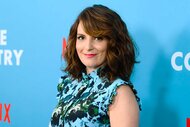 Tina Fey, wearing a blue floral top, smiles at the Wine Country World Premiere.