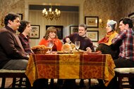 Various actors gathered around a table full of food during Thanksgiving during Saturday Night Live.