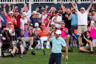 Scottie Scheffler pumps his fist in the air on the 18th green during the final round of THE PLAYERS Championship