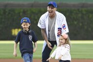 David Eigenberg with his children throw the first pitch the Chicago Cubs game