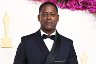 Sterling K. Brown smiles on the red carpet at the 2024 Oscars