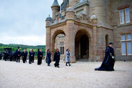 Alan Cumming and The Traitors Season 2 cast march outside the castle during Season 2 Episode 4.