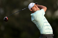 Scottie Scheffler of the United States plays his shot from the 18th tee during the third round of the 123rd U.S. Open Championship