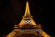 The Olympic rings on the lit up Eiffel Tower at nigh