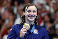 Katie Ledecky holds her gold medal at the 2024 Olympics