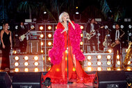 Miley Cyrus wears a pink caftan during a performance on New Years Eve 2021