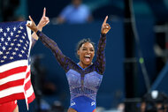 Simone Biles cheers after winning gold at the 2024 olympics