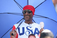 Snoop Dogg holds an umbrealla at the 2024 Olympics