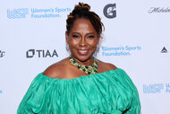 Wendy Hilliard wears a green dress to an event honoring women in sports