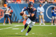 Caleb Williams of the Chicago Bears sets to throw during the fourth quarter of an NFL football game