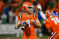 The Quarter back for the Fighting Illini during about to throw the ball on the football field