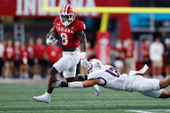 Indiana Hoosiers running back Kaelon Black runs with the ball while pursued by Western Illinois Leathernecks linebacker Ryan Crandall