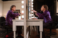 Mick Jagger sits as himself and Jimmy Fallon as Mick Jaggers reflection in an SNL skit