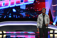 Austyns Stancil stands on The Voice stage with a mic in his hand